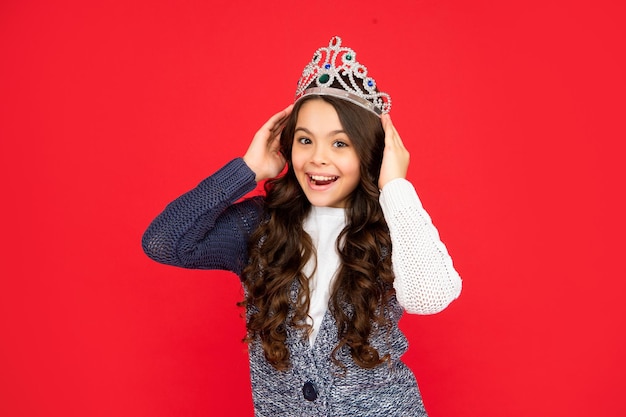 Feliz niño asombrado en reina corona princesa en tiara orgullosa niña adolescente usar diadema