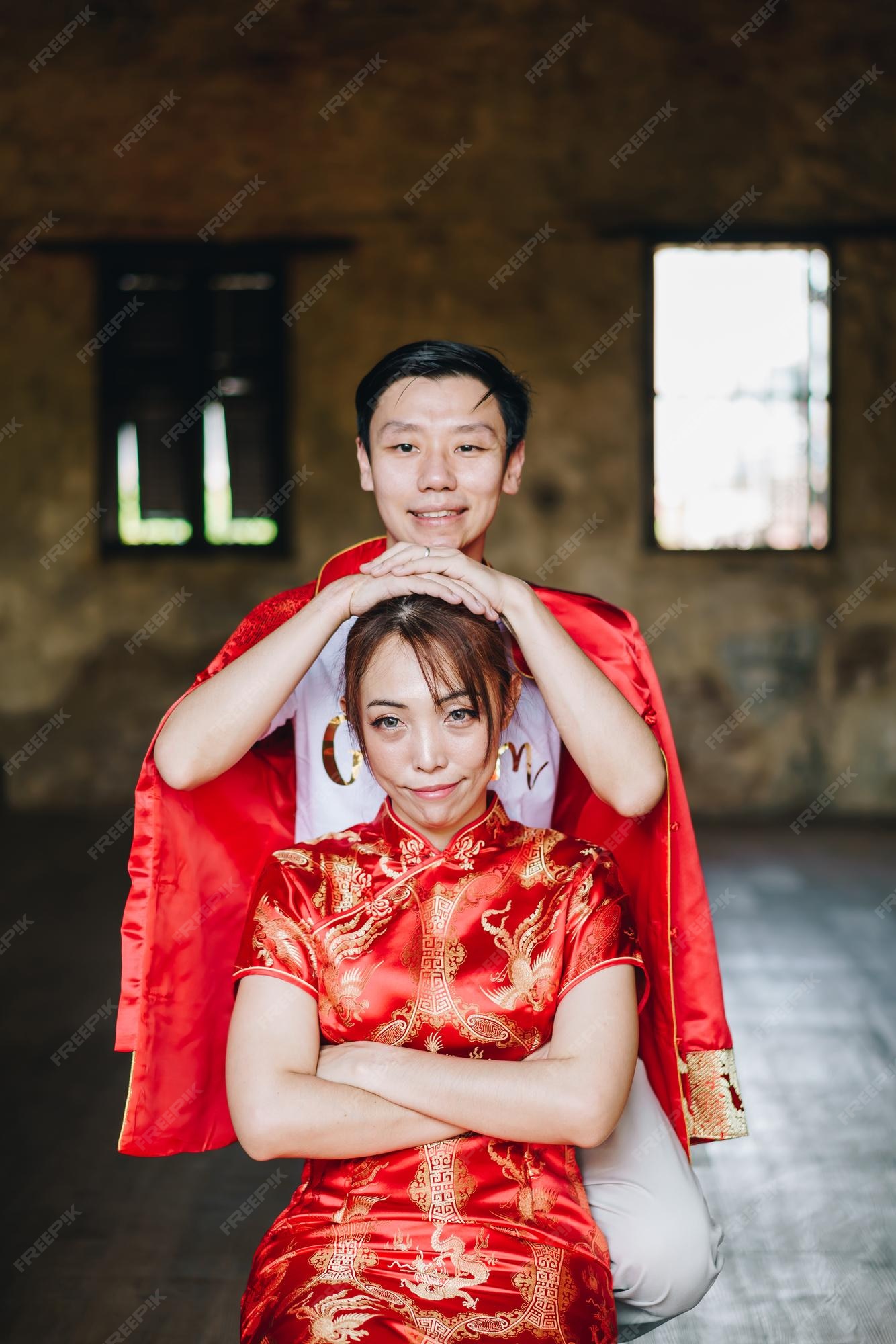 Feliz pareja asiática joven amor en tradicionales chinos - el rojo es el color principal de la fiesta tradicional que incluye la boda china. | Foto Premium