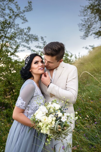 Feliz pareja de enamorados novios en el bosque.