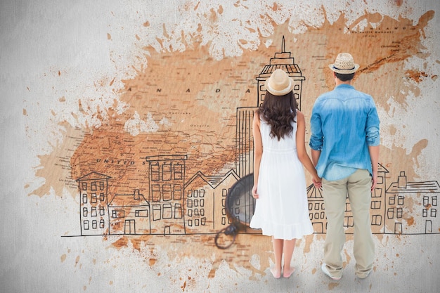 Feliz pareja hipster tomados de la mano contra el mapa mundial con brújula que muestra América del Norte