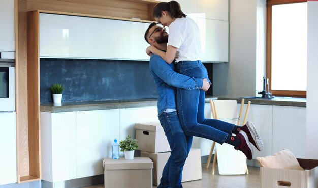 Feliz pareja joven sonriente mostrando las llaves de su nueva casa