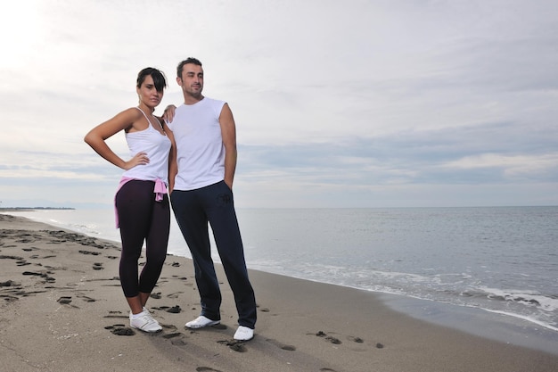 feliz pareja joven vestida de blanco tiene recreación romántica y diversión en la hermosa playa de vacaciones