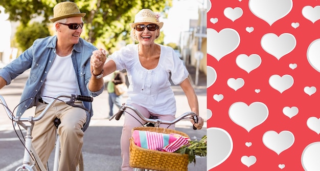 Feliz pareja madura yendo a dar un paseo en bicicleta en la ciudad contra el patrón del corazón