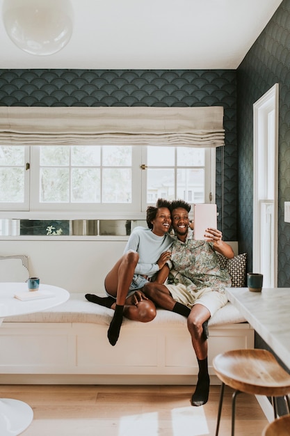 Feliz pareja negra tomando un selfie con una tableta digital