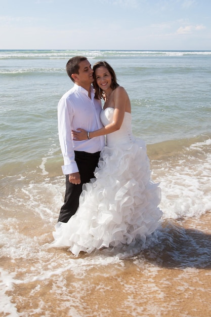 Feliz pareja recién casada en la playa