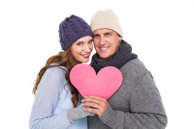 Feliz pareja en ropa de abrigo con corazón