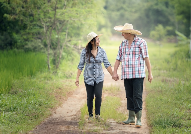 Feliz pareja senior dando un paseo en el campo de verano