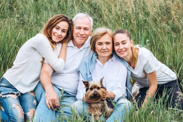 Feliz pareja senior con sus hijas en la naturaleza