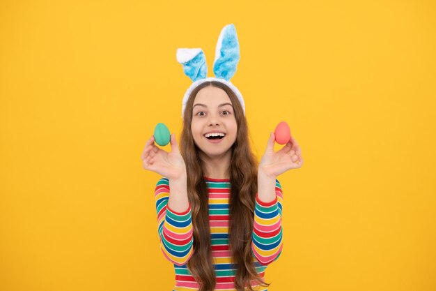 Feliz Páscoa menina adolescente em orelhas de coelho segurando ovos pintados para férias caça aos ovos, feriado da Páscoa.