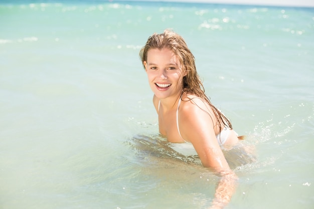 Feliz rubia bonita bañándose en el mar