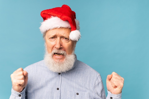 Feliz seguro fresco viejo barbudo santa claus ganador levantando los puños celebrando el triunfo y el éxito ov