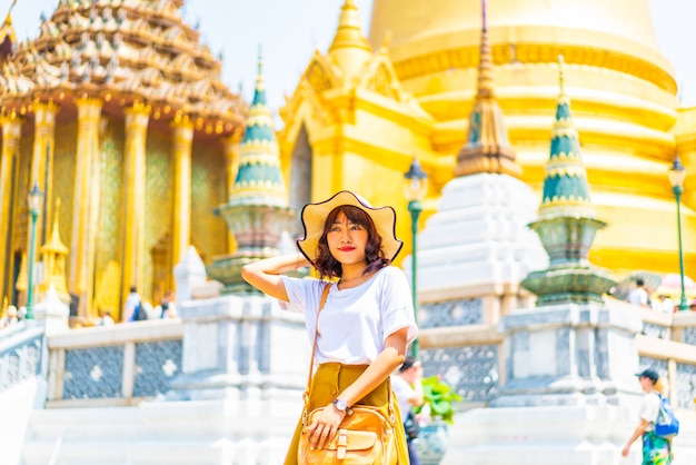 Feliz viagem asiática mulher no templo na Tailândia