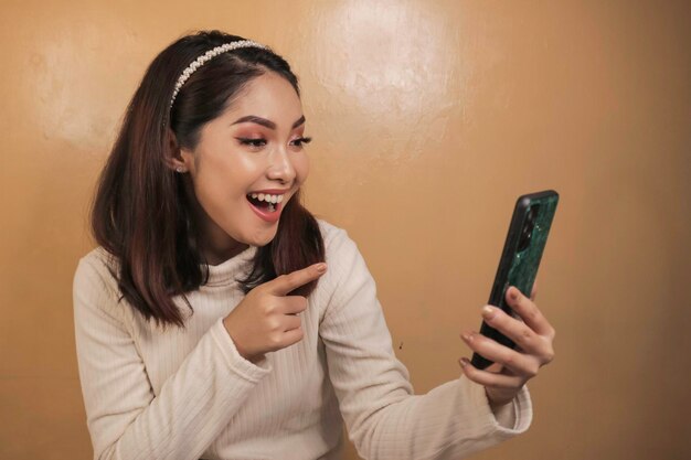 Felizes e sorridentes jovens mulheres asiáticas no telefone