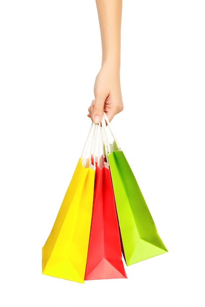 Feminino mão segurando sacolas de compras, isoladas