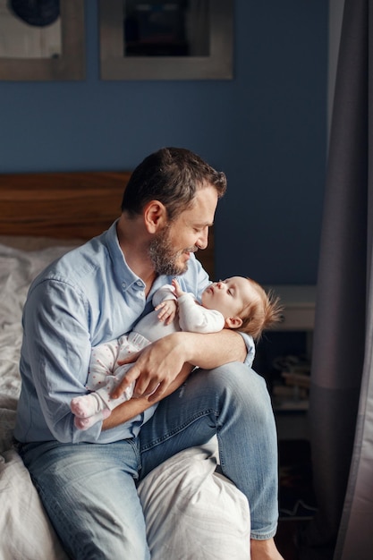 Feriado del día del padre padre de mediana edad con un bebé recién nacido durmiendo padre sosteniendo a su hija