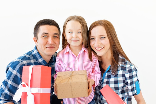 Feriados e conceito de celebração - família feliz com presentes de Natal em fundo branco.