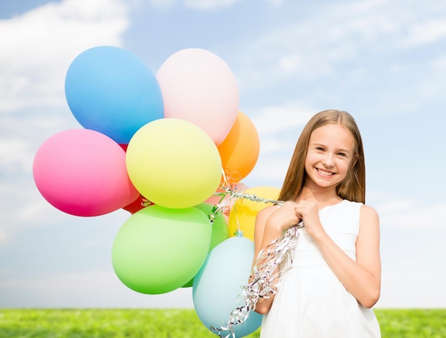 férias de verão, celebração, família, crianças e conceito de pessoas - garota feliz com balões coloridos