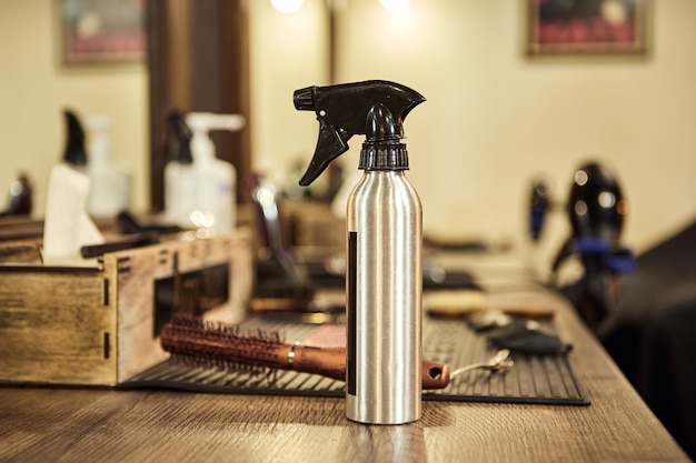 Ferramentas de cabeleireiro Spray de corte de cabelo e outras ferramentas ficam em cima da mesa na barbearia