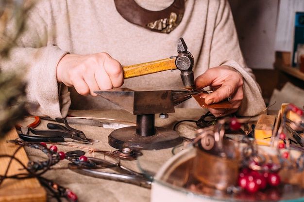 Ferramentas de trabalho feitas à mão em fio de cobre em cima da mesa com acessórios. conceito de arte de pessoas artesanato
