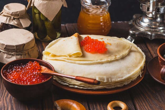 Foto festa de chá com panquecas, chá samovar e picles.