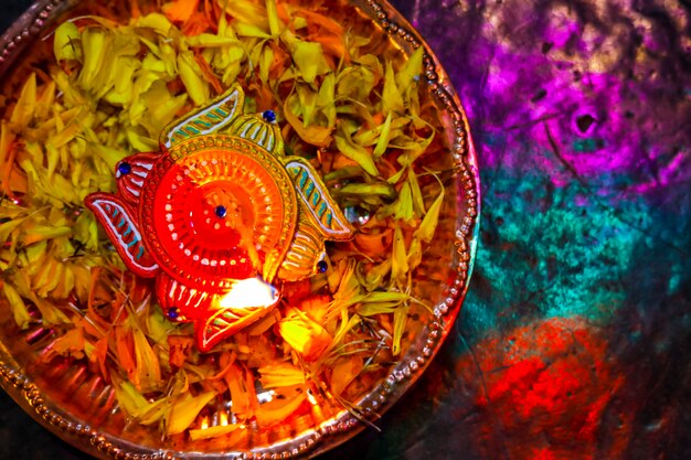 Festival indio de Diwali, lámpara y pétalos de flores de caléndula en pooja thali