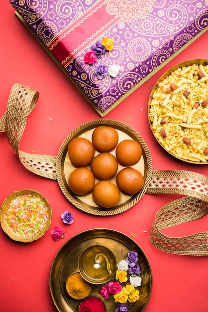 Festival Raksha bandhan: Rakhi conceptual hecho con plato lleno de dulce Gulab Jamun con banda y Pooja Thali.