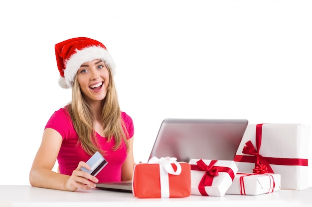 Festive blonde shopping online com laptop