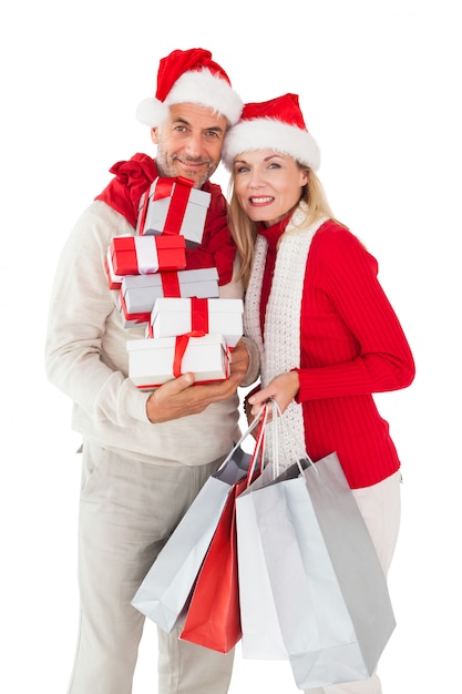 Festive couple holding presents and shopping bags