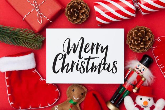 Festliche Botschaft auf weißem Papier mit einer Sammlung von Weihnachtsdekorationen