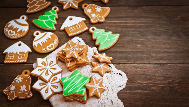 Festliche Weihnachtslebkuchenplätzchen in Form eines Sternes liegen auf einem hölzernen dunkelbraunen.