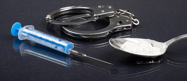Festnahme wegen Betäubungsmitteln, Handschellen Methamphetamin und Spritze.