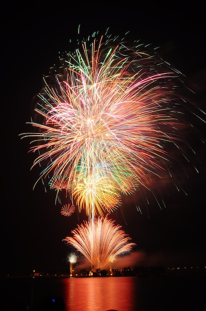 Feuerwerk erhellt den Himmel über dem Fluss.