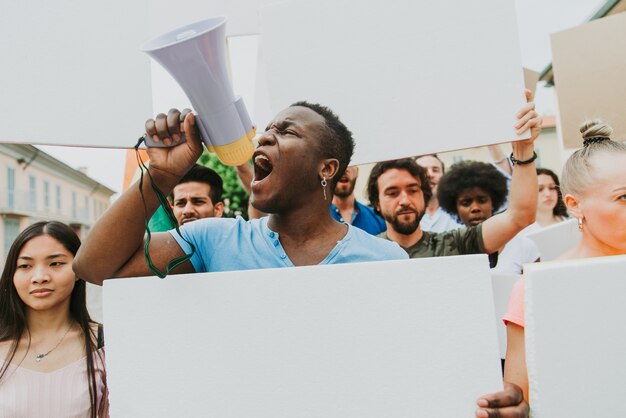 Öffentliche Demonstration auf der Straße gegen soziale Probleme und Menschenrechte. Gruppe multiethnischer Menschen, die öffentlich protestieren