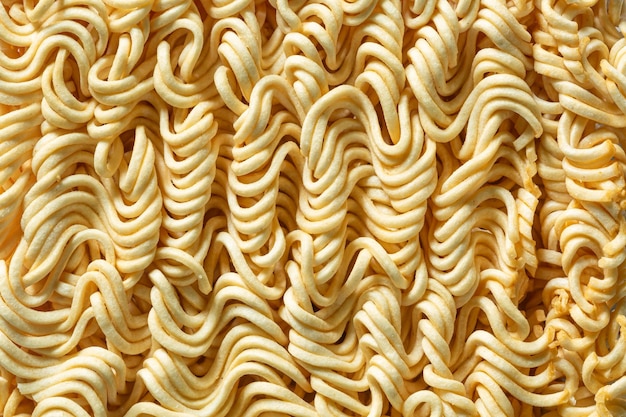 Fideos crudos instantáneos macro Primer plano de ramen crudo textura Vista superior del fondo de alimentos