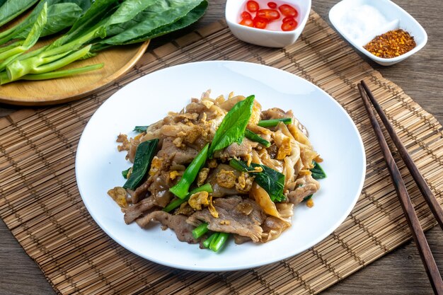 Foto fideos grandes fritos con salsa de soja un plato de pad see ew