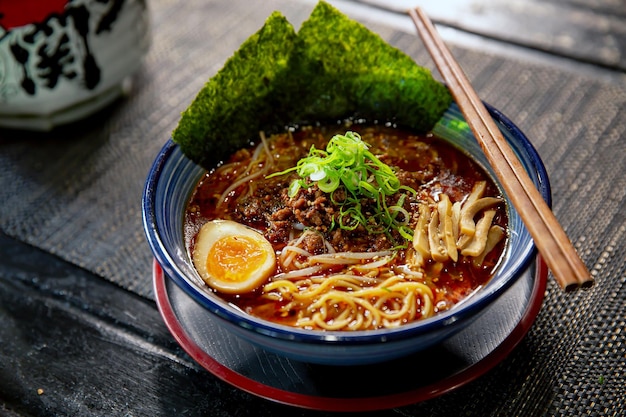 Fideos picantes de Sichuan Dandan ramen con palillos en el tradicional restaurante japonés de ramen con