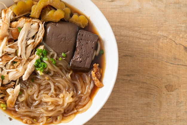 Fideos de pollo guisados en tazón de sopa marrón - Estilo de comida asiática