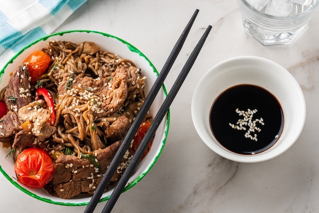 Fideos Soba con ternera, champiñones, tomate cherry y pimientos dulces. cocina asiática