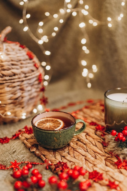 Fiesta del té por la noche con luces de Navidad, té caliente y dulces.