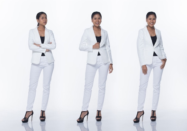 Figura instantánea de cuerpo entero, mujer de negocios asiática de pie en pantalones y zapatos de traje blanco formal adecuado, fondo blanco de iluminación de estudio aislado, acto de abogado jefe posando sonrisa mirada inteligente