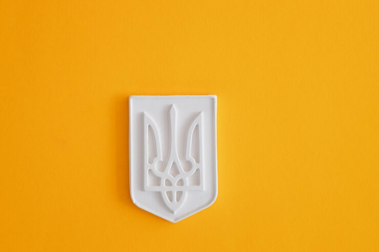 Foto figura de yeso del escudo de armas de ucrania tryzub sobre un fondo de color