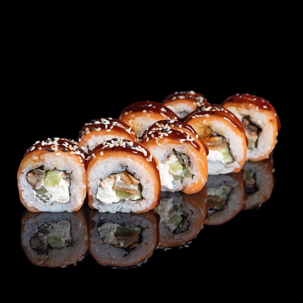 Filadelfia rollo en negro con reflejo en negro con reflejo. De cerca. Cocina japonesa. Filadelfia rollo en negro con reflejo en negro con reflejo. De cerca.