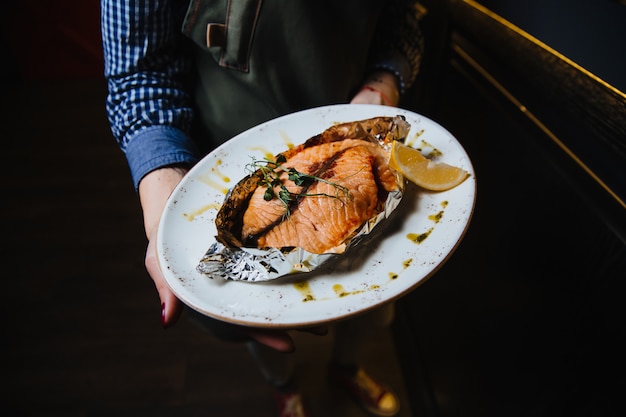 Filé de peixe assado suculento em um prato redondo