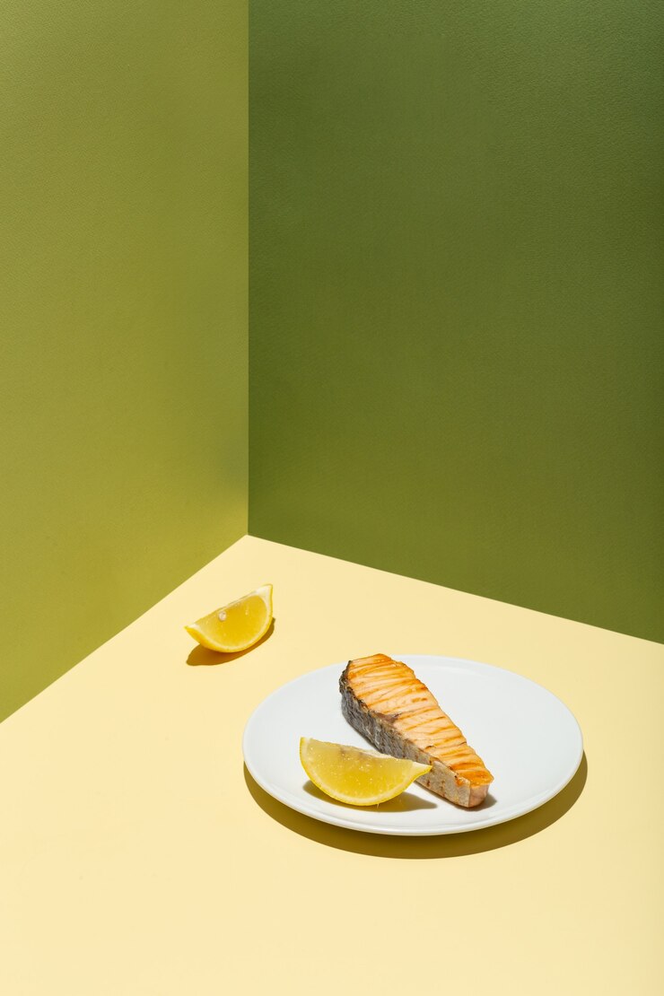 Filé de salmão assado com limão no prato branco duro moderno sombra verde fundo foto de alta qualidade