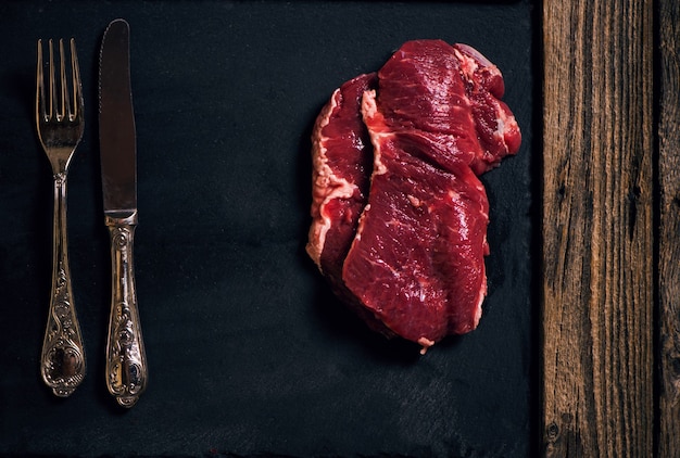 Un filete de carne cruda de mármol sobre un fondo negro