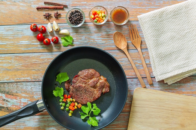 Filete de cerdo a la parrilla en una sartén sobre fondo oscuro vista superior