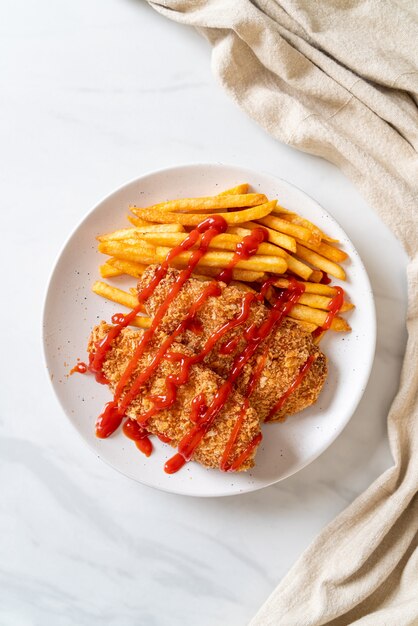 Filete de pechuga de pollo frito con papas fritas y salsa de tomate