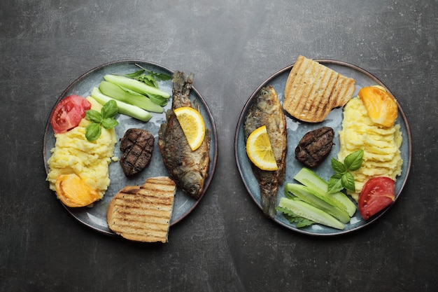 Filete de pescado frito, carne y verduras en un plato