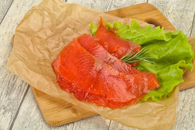 Filete de salmón en rodajas servido con romero