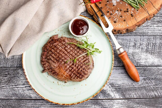 Filete de ternera bistec de ternera a la parrilla sobre un fondo blanco de madera